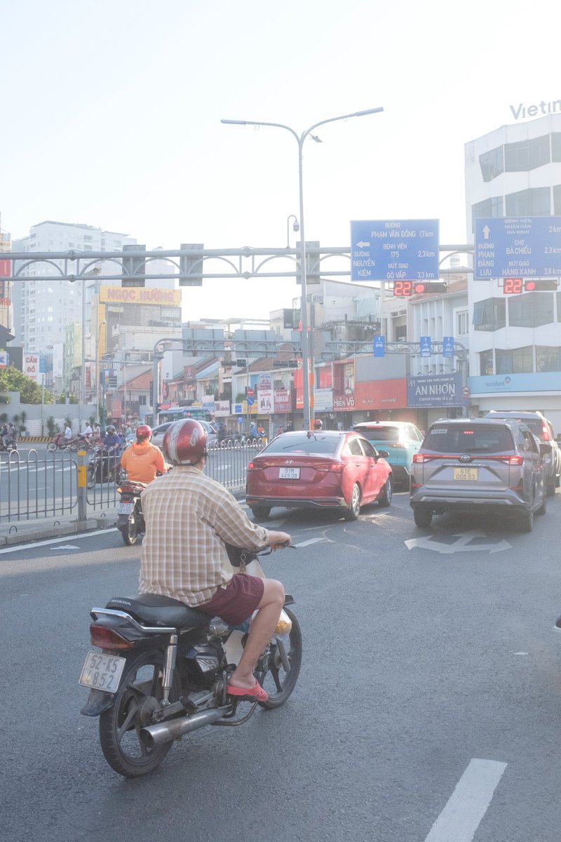 Edit city photo into rainy scene with Vietnamese bikers