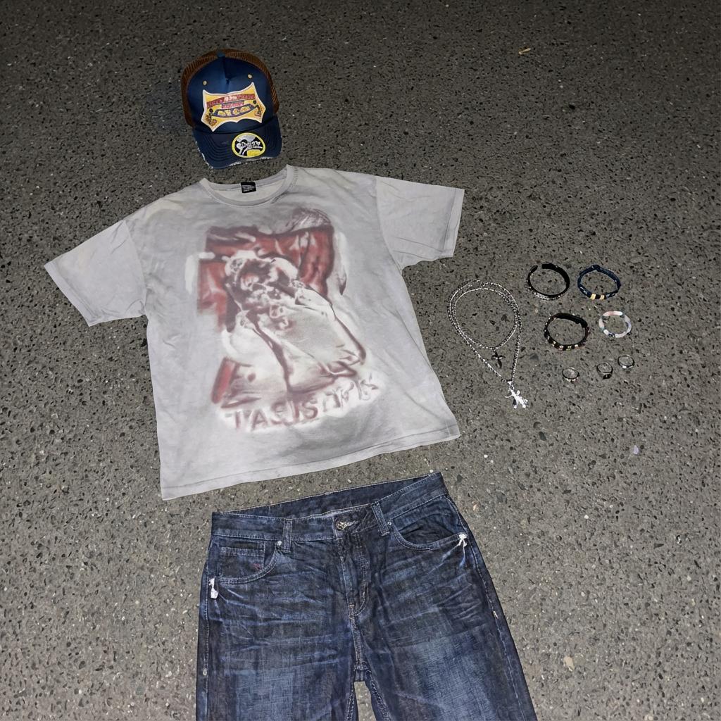 Clothing items laid out on asphalt 2